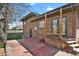 Back exterior featuring a deck, brick facade, and access to a fenced yard at 3901 Newland St, Wheat Ridge, CO 80033