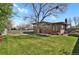 Large backyard with mature tree, fence, and exterior of a brick home at 3901 Newland St, Wheat Ridge, CO 80033