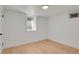 Bright basement space with updated light-colored flooring, a window, and white painted walls at 3901 Newland St, Wheat Ridge, CO 80033