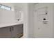 Updated basement bathroom featuring a vanity, quartz countertop, and adjacent laundry hookups at 3901 Newland St, Wheat Ridge, CO 80033