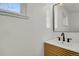 Bright bathroom featuring a modern vanity and mirror at 3901 Newland St, Wheat Ridge, CO 80033