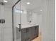 Basement bathroom with walk-in shower, vanity with undermount sink, and quartz countertop at 3901 Newland St, Wheat Ridge, CO 80033