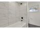 Bathroom with a white tiled shower and tub combination at 3901 Newland St, Wheat Ridge, CO 80033