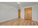 Bedroom with hardwood floors, double closets, and freshly painted white walls at 3901 Newland St, Wheat Ridge, CO 80033