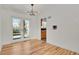 Bright dining area features hardwood floors, modern lighting, and access to the kitchen and backyard deck at 3901 Newland St, Wheat Ridge, CO 80033