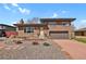 Charming brick home featuring a two-car garage, manicured landscaping, and a welcoming entrance at 3901 Newland St, Wheat Ridge, CO 80033