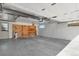 Spacious two car garage with wooden work bench and shelving at 3901 Newland St, Wheat Ridge, CO 80033