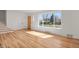 Spacious living area boasting hardwood floors, a large window, and plenty of natural light at 3901 Newland St, Wheat Ridge, CO 80033