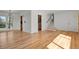 Sun-drenched living room showcasing hardwood floors, a modern staircase, and backyard views at 3901 Newland St, Wheat Ridge, CO 80033
