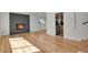 Bright and airy living room features hardwood floors, a modern fireplace, and fresh paint at 3901 Newland St, Wheat Ridge, CO 80033