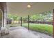 Covered patio overlooking a well-maintained backyard with mature trees and privacy fence at 2556 S Eagle Cir, Aurora, CO 80014