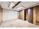 Partially finished basement with wood paneled walls, a small window and closet space at 2556 S Eagle Cir, Aurora, CO 80014