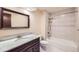 Bathroom with tub and shower, marble vanity and modern fixtures at 2556 S Eagle Cir, Aurora, CO 80014