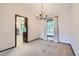 Inviting dining room with large windows, neutral carpeting, and a modern chandelier at 2556 S Eagle Cir, Aurora, CO 80014