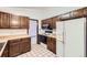 Well-appointed kitchen with abundant cabinet space and sleek, white appliances at 2556 S Eagle Cir, Aurora, CO 80014