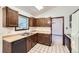 Functional kitchen design featuring dark wood cabinets, neutral countertops, and modern appliances at 2556 S Eagle Cir, Aurora, CO 80014