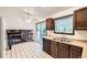 Bright and airy kitchen with sliding glass doors, tile floors, and plenty of cabinet space at 2556 S Eagle Cir, Aurora, CO 80014