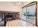 Bright kitchen with sliding glass doors to a patio, neutral tile flooring, and a view of the cozy Gathering room below at 2556 S Eagle Cir, Aurora, CO 80014