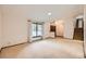Spacious living room boasts natural light, plush carpeting, and an open staircase at 2556 S Eagle Cir, Aurora, CO 80014