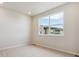 Bright bedroom with neutral carpet and a large window at 457 Interlocken Blvd # 103, Broomfield, CO 80021