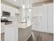 Stylish white kitchen features an island, stainless appliances, and abundant cabinetry at 457 Interlocken Blvd # 103, Broomfield, CO 80021