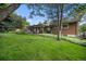 Backyard featuring a lush lawn, a covered patio and mature trees at 8299 E Kenyon Ave, Denver, CO 80237