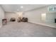 Spacious carpeted basement with ample room for seating and entertainment at 8299 E Kenyon Ave, Denver, CO 80237