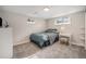 Comfortable bedroom with soft lighting, neutral walls and gray carpet at 8299 E Kenyon Ave, Denver, CO 80237