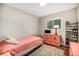 Comfortable bedroom with hardwood floors, a twin bed, a vintage dresser, and plenty of storage at 8299 E Kenyon Ave, Denver, CO 80237