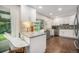Bright eat-in kitchen featuring granite countertops, white cabinets, stainless appliances, and hardwood floors at 8299 E Kenyon Ave, Denver, CO 80237