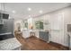 Well-lit kitchen featuring granite countertops, white cabinets, hardwood floors, and a view of the backyard at 8299 E Kenyon Ave, Denver, CO 80237
