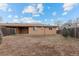 View of the back exterior of the house showcasing its brick facade and wooden fence at 8661 W 32Nd Pl, Wheat Ridge, CO 80033