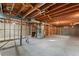 Unfinished basement space with wood beam ceilings, utilities, and concrete flooring at 8661 W 32Nd Pl, Wheat Ridge, CO 80033
