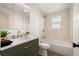 Bright bathroom featuring modern fixtures, stylish tiling and a combined tub and shower at 8661 W 32Nd Pl, Wheat Ridge, CO 80033