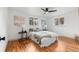 Light bedroom with hardwood floors, fan and two windows allowing ample natural light at 8661 W 32Nd Pl, Wheat Ridge, CO 80033