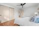 Bright bedroom showcasing hardwood floors, a fan, and closet with sliding doors at 8661 W 32Nd Pl, Wheat Ridge, CO 80033