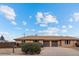 Daytime view of single story brick home with dual car garage and manicured landscaping at 8661 W 32Nd Pl, Wheat Ridge, CO 80033