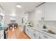 Bright kitchen with quartz countertops, white cabinetry, and stainless steel appliances at 8661 W 32Nd Pl, Wheat Ridge, CO 80033