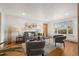 Bright living room featuring hardwood floors, neutral paint, stylish furniture, and a large window at 8661 W 32Nd Pl, Wheat Ridge, CO 80033