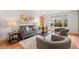 Comfortable living room showcasing a plush sofa, cozy chairs, and abundant natural light at 8661 W 32Nd Pl, Wheat Ridge, CO 80033