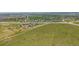 A sprawling green field with a building, set against a distant neighborhood at 4422 E Andover Ave, Castle Rock, CO 80104