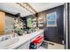 Bathroom boasts double sinks with ample countertop space, vanity lighting, and storage shelves at 4422 E Andover Ave, Castle Rock, CO 80104