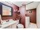 Bathroom with dark brown walls, tile floors and white sink and toilet at 4422 E Andover Ave, Castle Rock, CO 80104