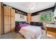 Bedroom with neutral walls, wardrobes, leather couch and blacked out accent wall at 4422 E Andover Ave, Castle Rock, CO 80104