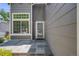 Inviting front entrance featuring a tiled patio and a well-lit doorway at 4422 E Andover Ave, Castle Rock, CO 80104