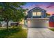 Charming two-story home featuring a well-maintained lawn and an attached two-car garage at 4422 E Andover Ave, Castle Rock, CO 80104