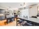 Open kitchen boasts granite countertops, gray cabinets, stainless appliances and hardwood floors at 4422 E Andover Ave, Castle Rock, CO 80104