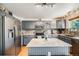 Bright kitchen features stainless appliances, granite countertops, tile backsplash and a large island at 4422 E Andover Ave, Castle Rock, CO 80104