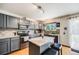 Gray kitchen boasts stainless appliances, granite counters, tile backsplash and outdoor access at 4422 E Andover Ave, Castle Rock, CO 80104