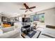 Open-concept living room showcasing the updated kitchen and hardwood floors at 4422 E Andover Ave, Castle Rock, CO 80104